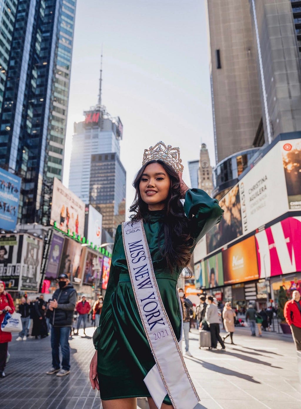 Marizza wearing her “Miss New York 2021” sash in the middle of Times Square, New York City, New York, USA