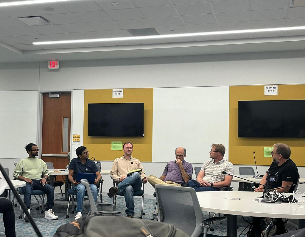 Panelists sitting in a half circle