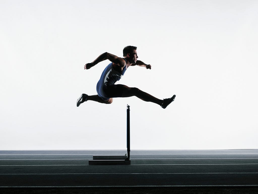 Image demonstrating agility, athlete jumping over a hurdle