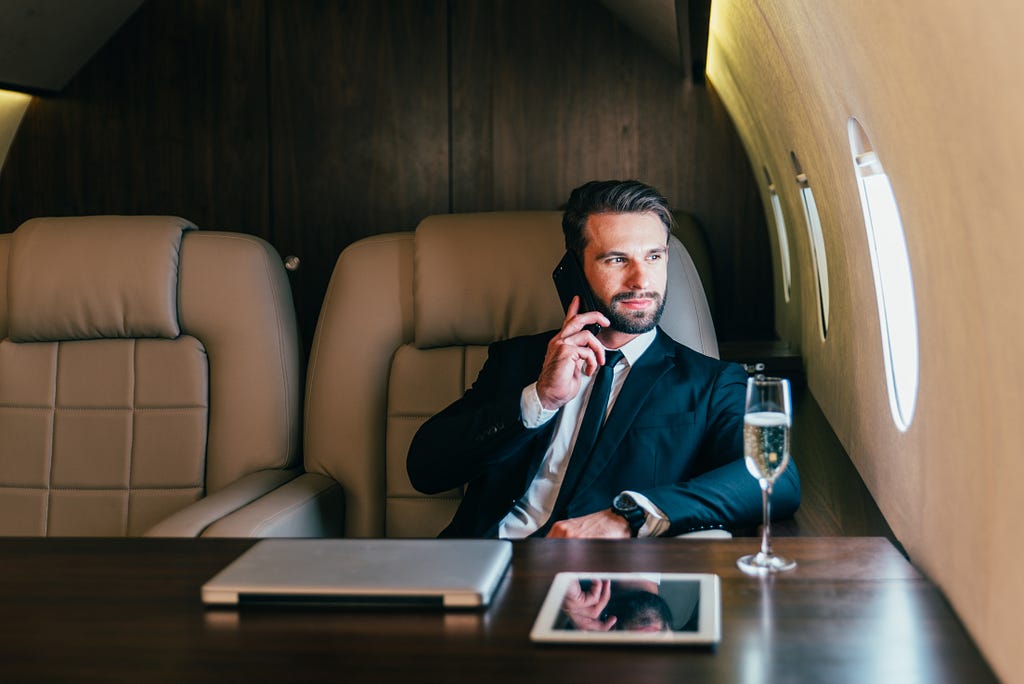 A businessman doing his meeting inside Best Executive Jet Charter by Global Charter