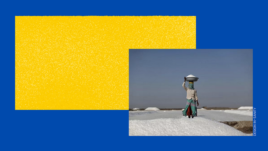 Image showing an Agariya woman carrying a large container filled with course salt on her head.