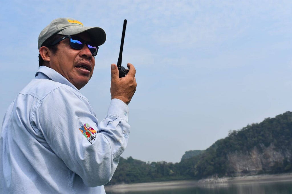 Enrique Valenzuela communicates via walkie-talkie with other Lacandón park guards.