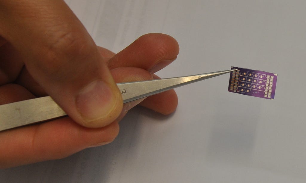 A pair of tweezers hold a small nanosensor