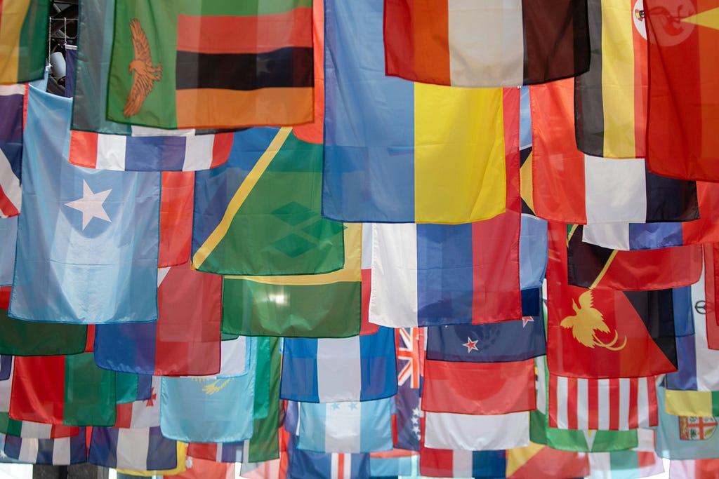 A photo of many different flags hanging together.