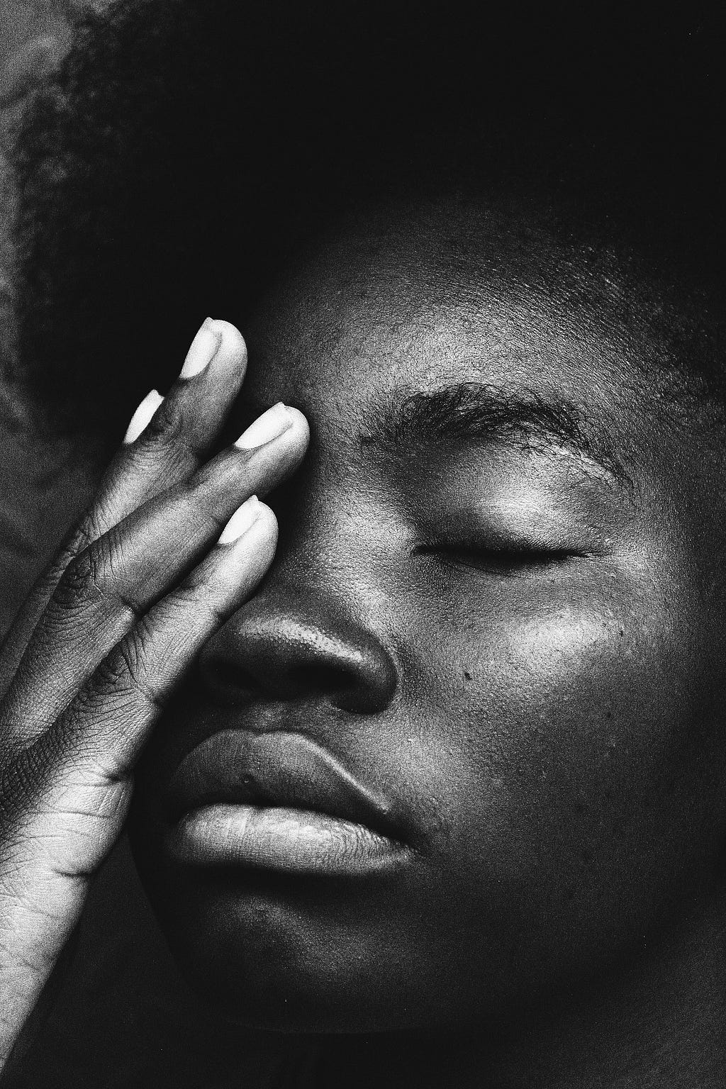 Black women tired with her face in her hands