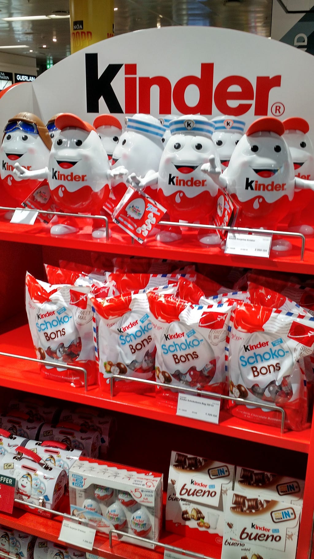 Store rack of a variety of Kinder chocolate candies, including Kinder Eggs.