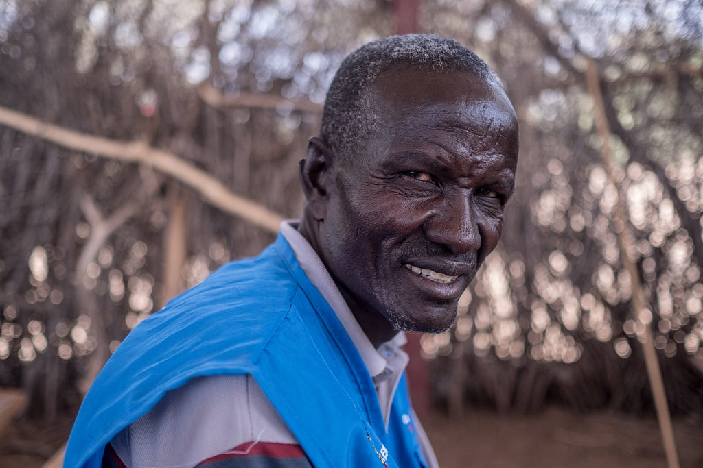 A portrait of community health volunteer John Ekutan in the local church where surgeries will take place