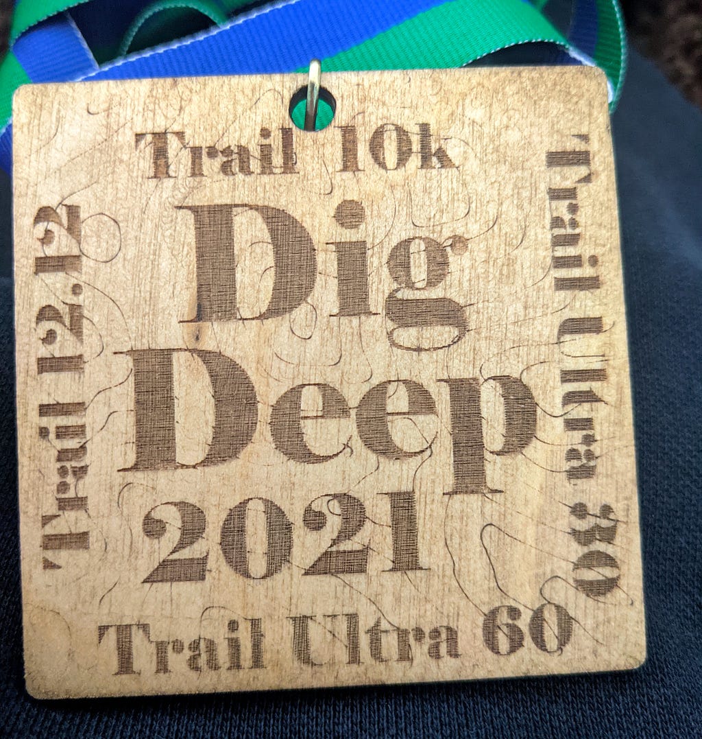 Dig Deep medal — wooden and square and says ‘Dig Deep 2021’ on it.