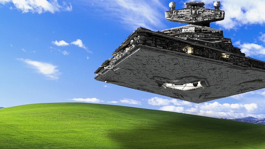 An Imperial Star Destroyer floating over a classic wallpaper featuring a hill of green grass with the backdrop of a blue sky with clouds