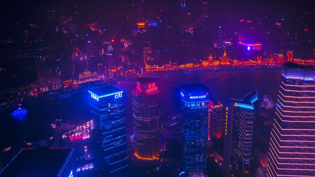 A cityscape is covered in neon blue and red lights to look futuristic.