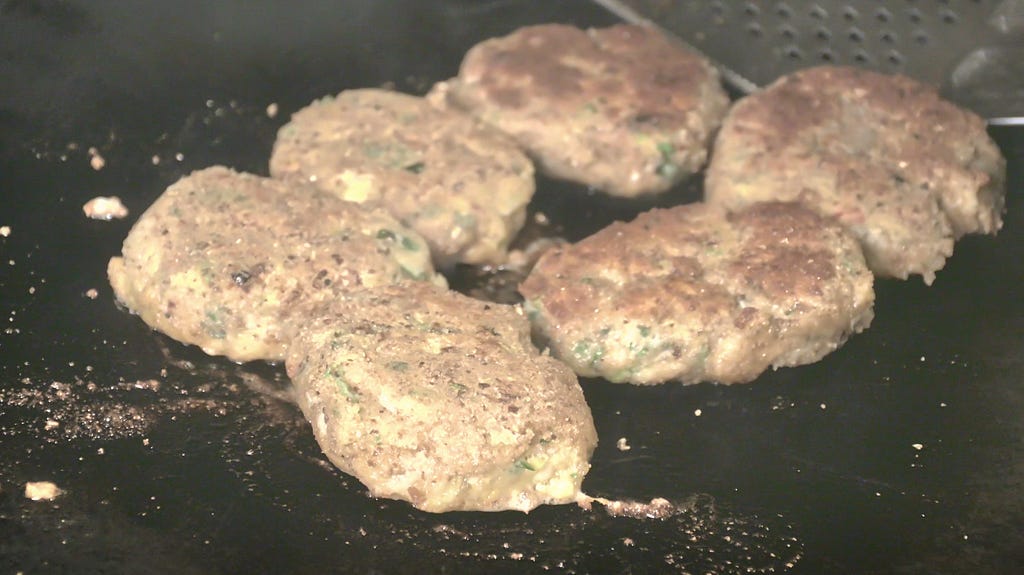 Fish cakes frying on the tawa