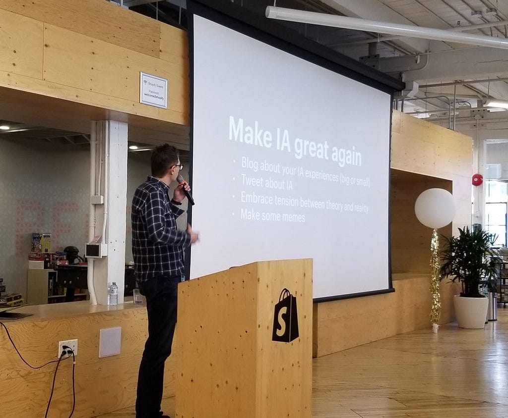 The author giving an IA talk in February 2020 in Toronto. The screen beside him reads “Make IA great again.”