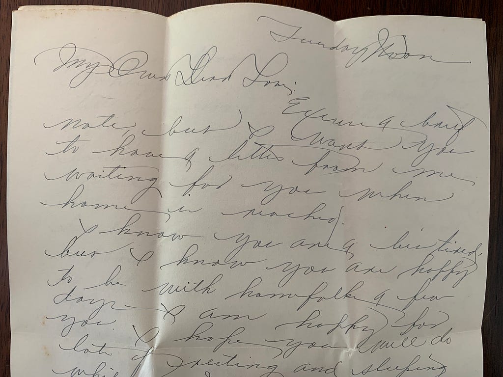 close up of one page of a letter with very swoopy cursive writing