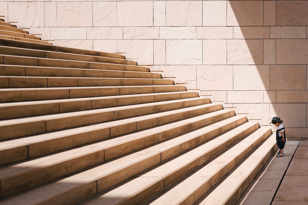 Kid looking at a long stairs