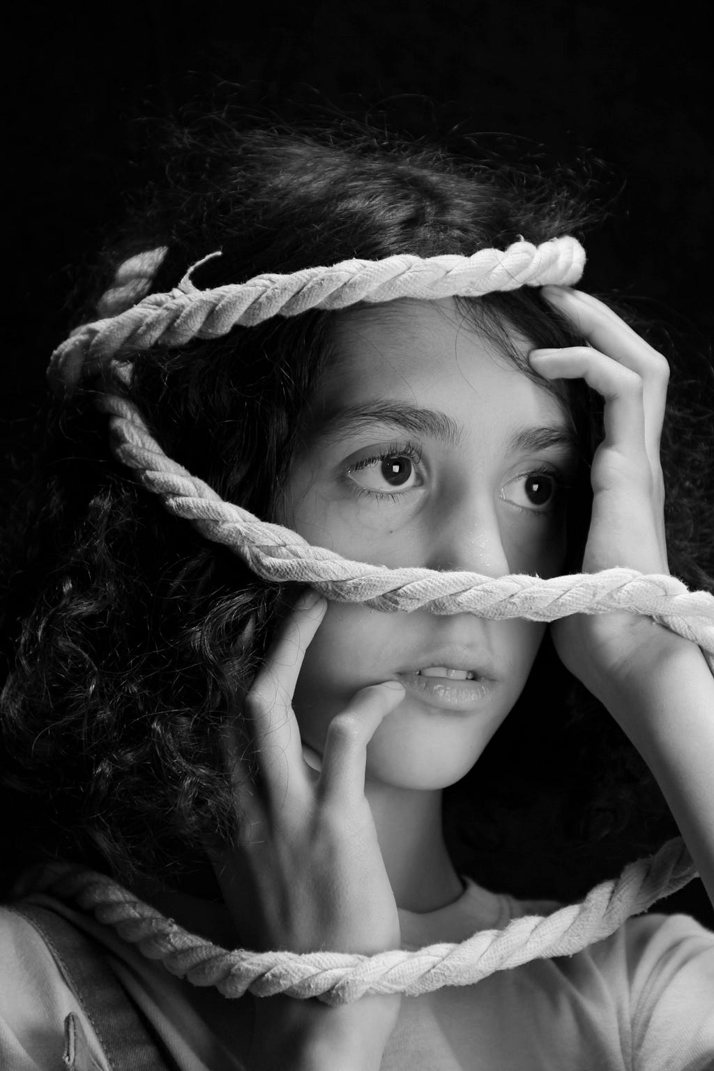 Young girl with rope around her