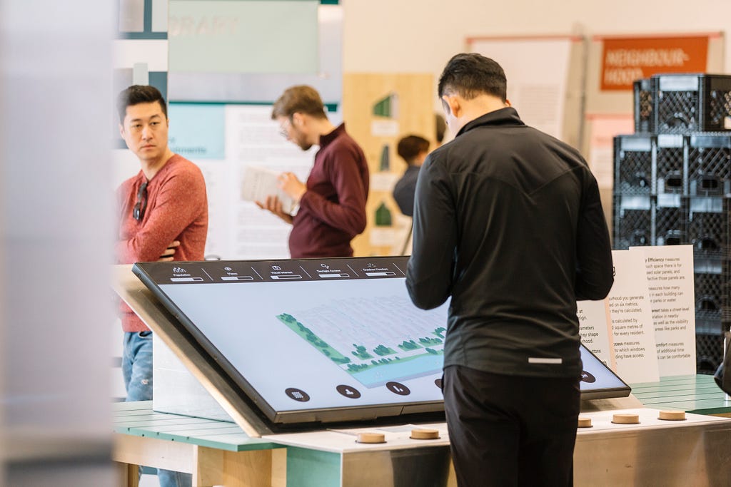 An individual looking at an interactive screen at 307 Lake Shore Blvd. E, Sidewalk Labs’ Toronto headquarters.