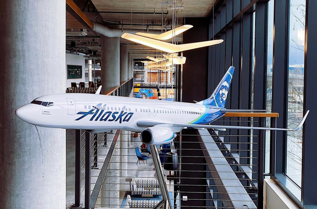 Picture of a mid-size model airplane in a well lit office building