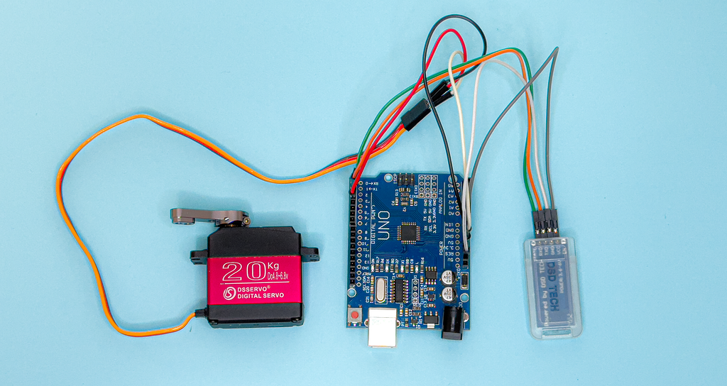 An Arduino set connected to a servo and a Bluetooth module.