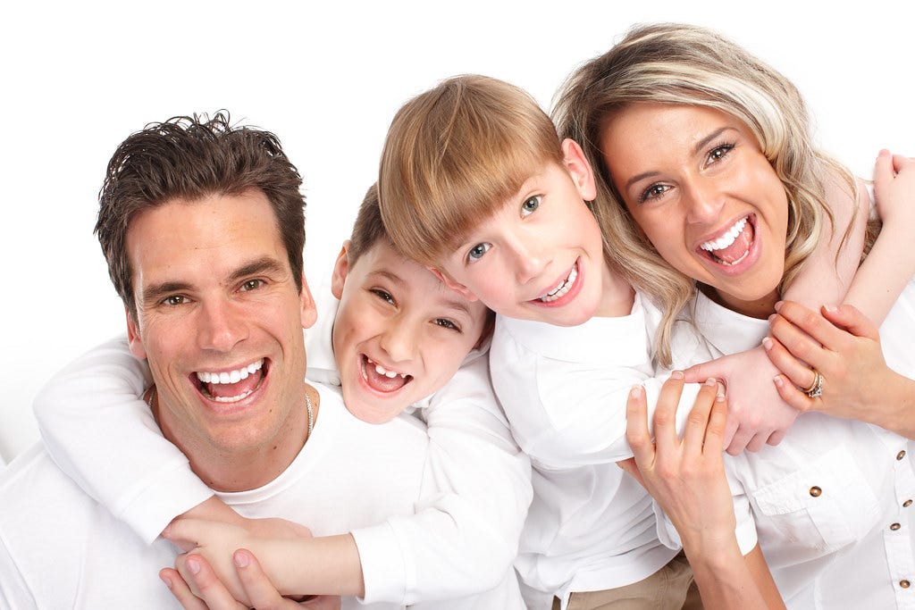 Eligibility Criteria for New Zealand Immigration. The image shows a group picture of a family with smiles on their faces.