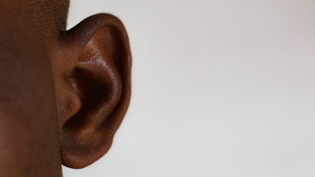 A close up image of someones ear on a blank canvas