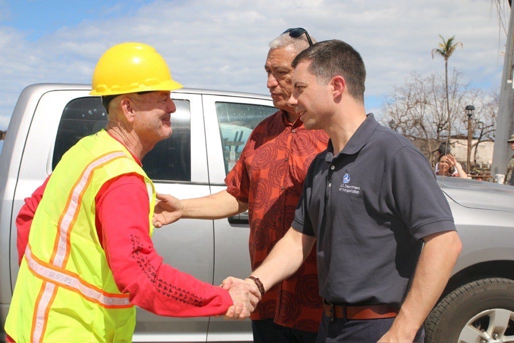 Secretary Buttigieg greets a worker who has been aiding in the disaster recovery