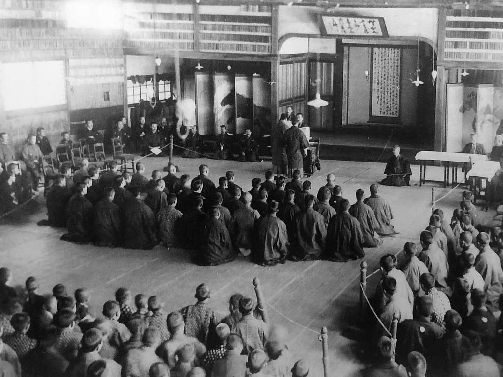 Jigoro Kano delivering a lecture to students. Kano eventually became one of the most influential figures in Japanese history. Seiryoku Zenyo was just one philosophy, another, Jita Kyōei, encouraged citizens to always act in a way that was mutually beneficial to other citizens.