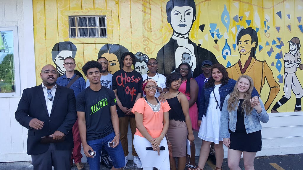 A community group stands in front of the new mural in Yspilanti, Michigan.