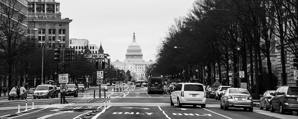 DC street traffic. Capitol building in the background