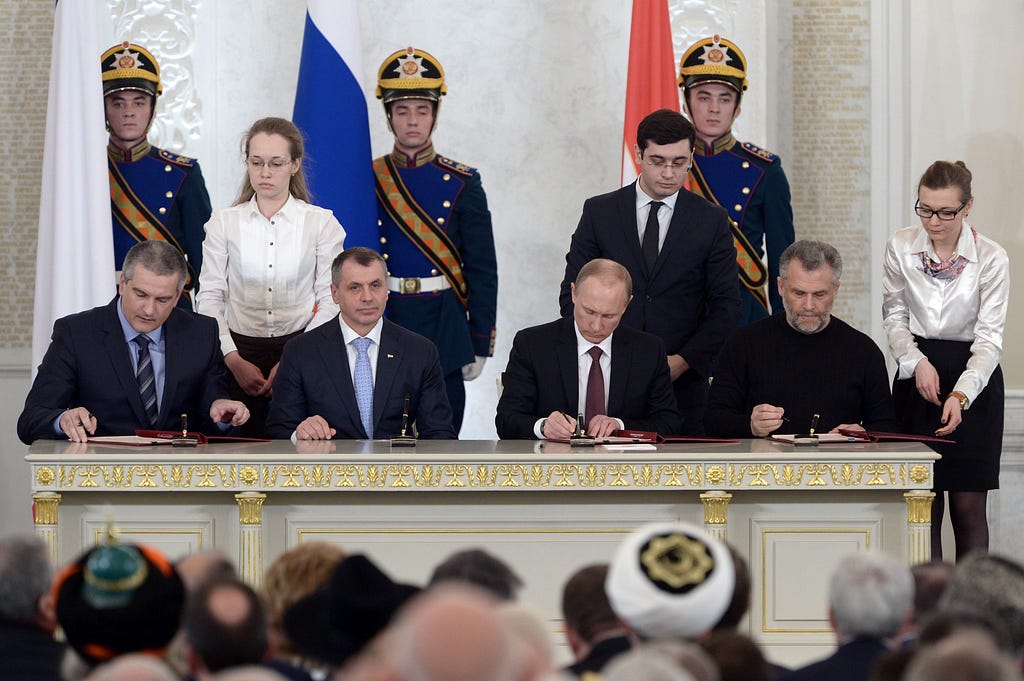 Putin and Aksyonov formalizing the annexation
