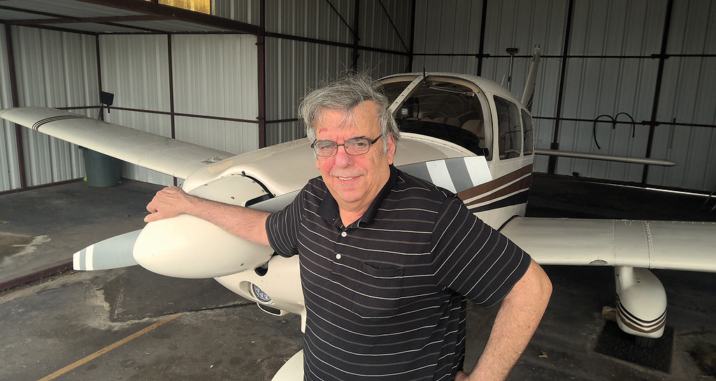 Photo of Allan Kash and his airplane.