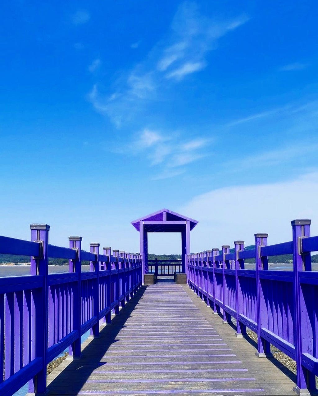 A part of the long bridge with purple wooden sides.
