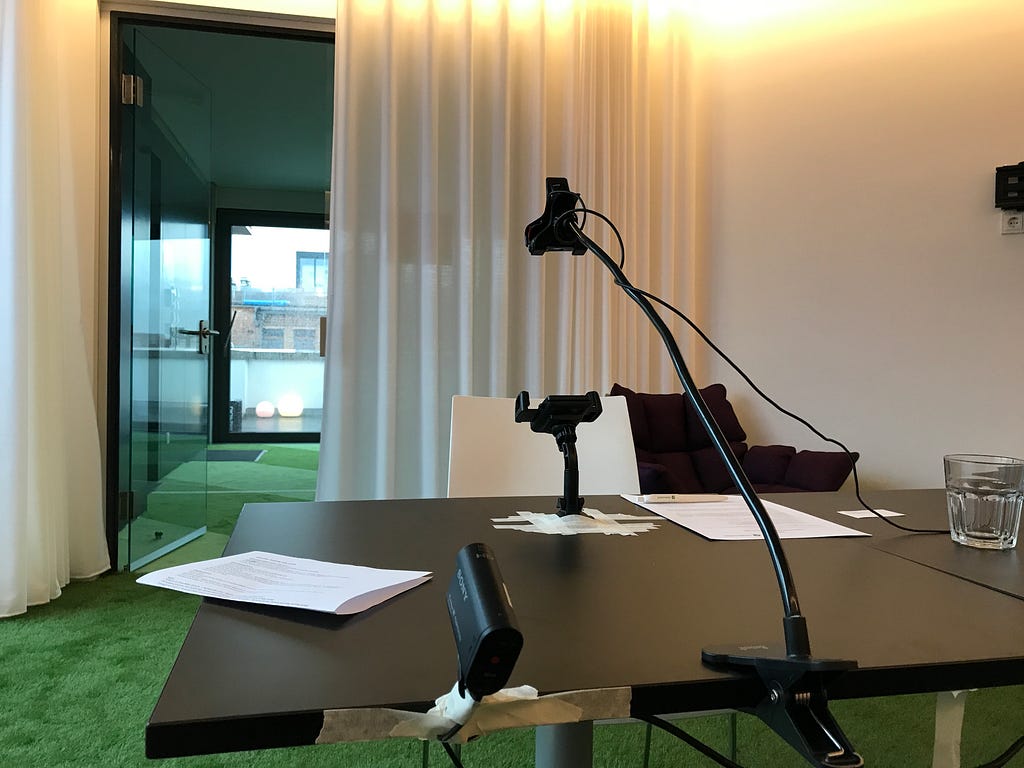 A usability testing setup with two simple cameras and a phone holder