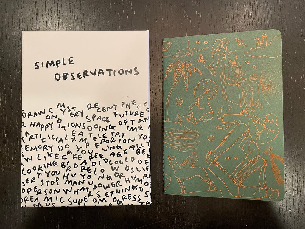 Two notebooks on a table. One is titled Simple Observations, the other is a sketch book.