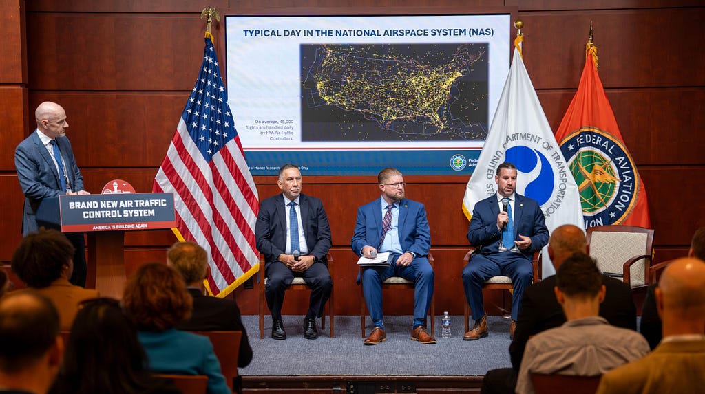 The FAA’s Thomas Draffen (at podium) is joined by fellow aviation representatives on a panel focused on improving air traffic telecommunications. (Photo: DOT)