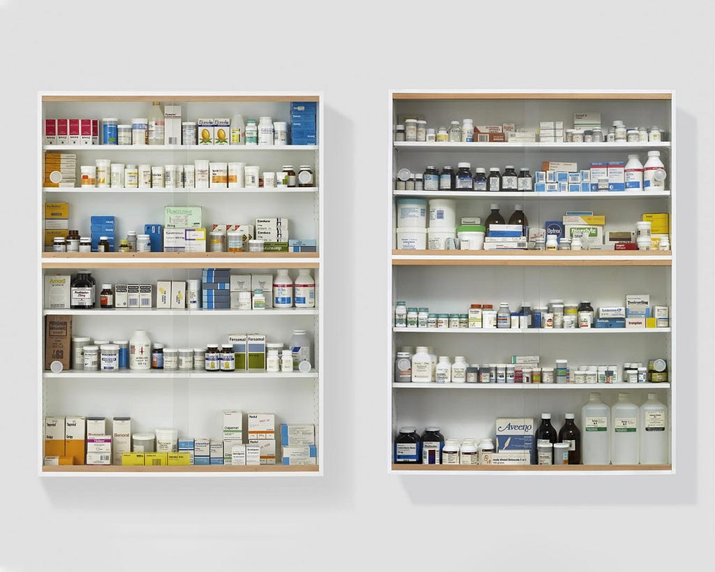 Two medicine cabinets, filled with pharmacy style packaging and medicine containers.