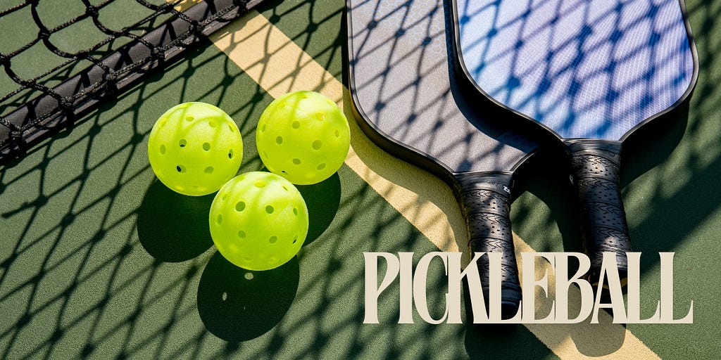 image of a set of pickleball balls a net and some paddles