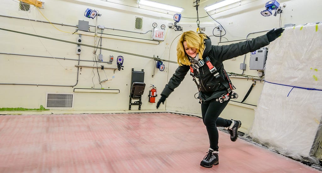 A scientists at The KITE Research Institute testing a winter boot in the lab to determine its slip resistance.