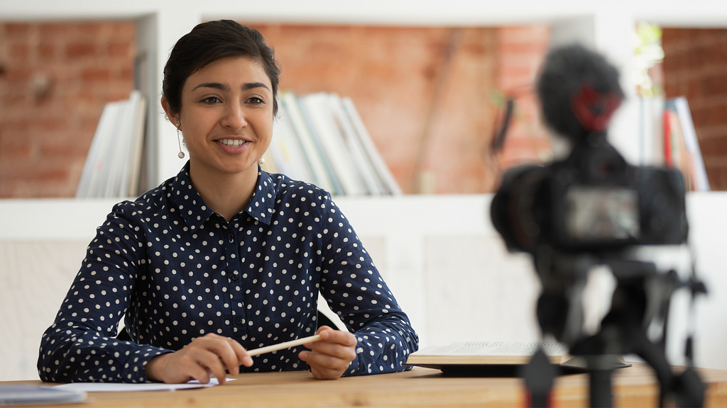 Girl In front of a camera creating a video resume