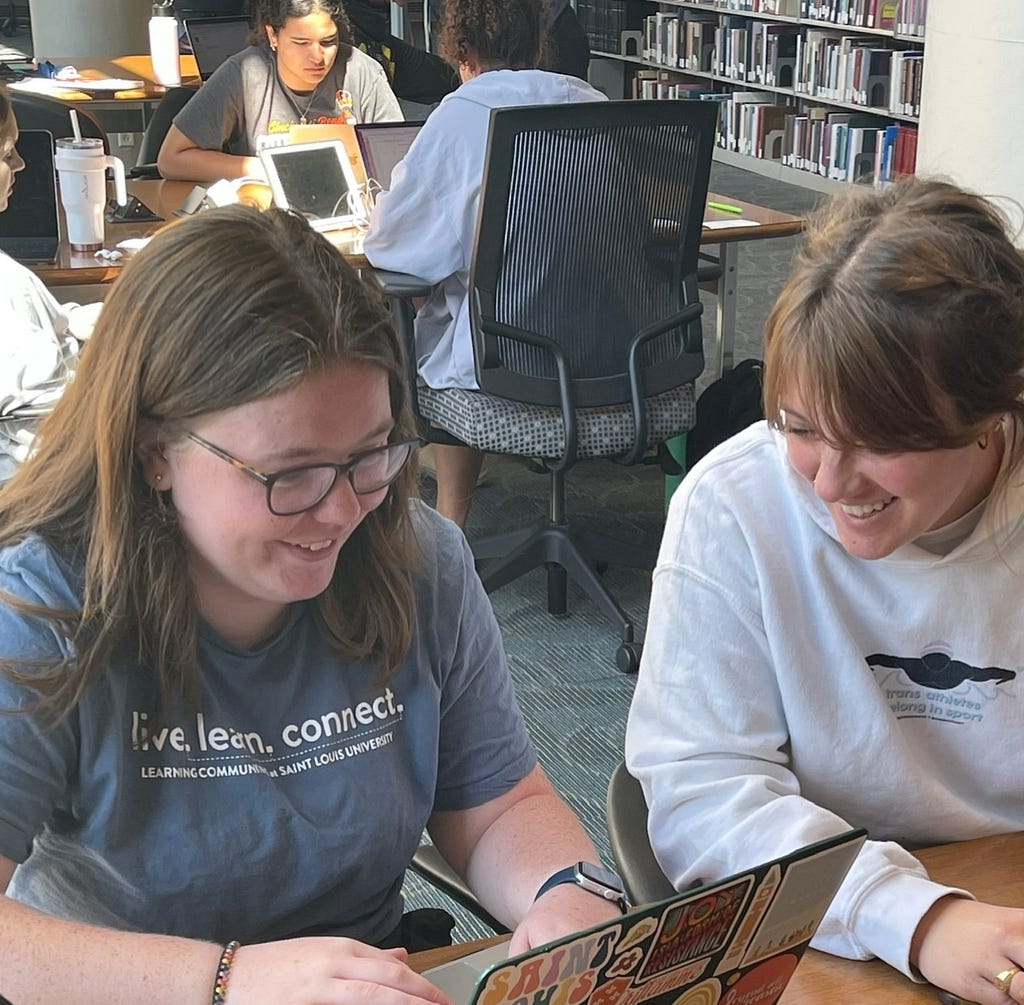 Pius Xii Memorial Library at Saint Louis University is a popular spot on campus for students to get homework done, study with friends, and share a laugh. Jackie Barnes and McKenna Anderson are seen here doing all of the above as Jackie Barnes helps McKenna Anderson study for her biology test while also doing her own homework. As shown above, on September 25, 2022, the two students were laughing as they explain they are, “laughing through the pain” of looking over McKenna Anderson’s notes.