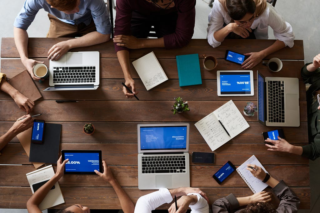 A product development team in a meeting discussing product and business alignment.