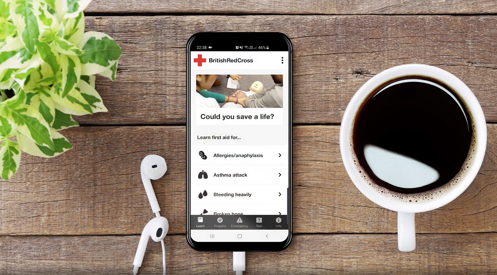 The British Red Cross First aid app is displayed on a phone.