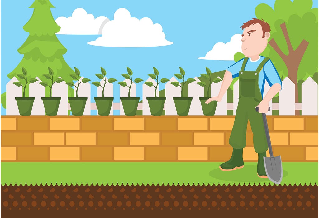 A man dressed in overalls holding a spade looks suspiciously at a row of plants.