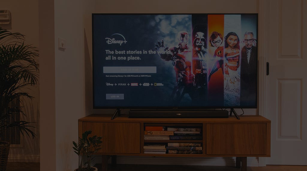A living room TV turned on to Disney+.