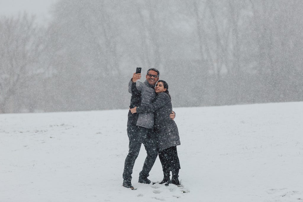 Sometimes you have to work with what the weather gods offer. Erico Fileno and Carole Zatorre, from Brazil, take a selfie in the snow outside the Interaction Awards ceremony at the end of Interaction 19 in Seattle.