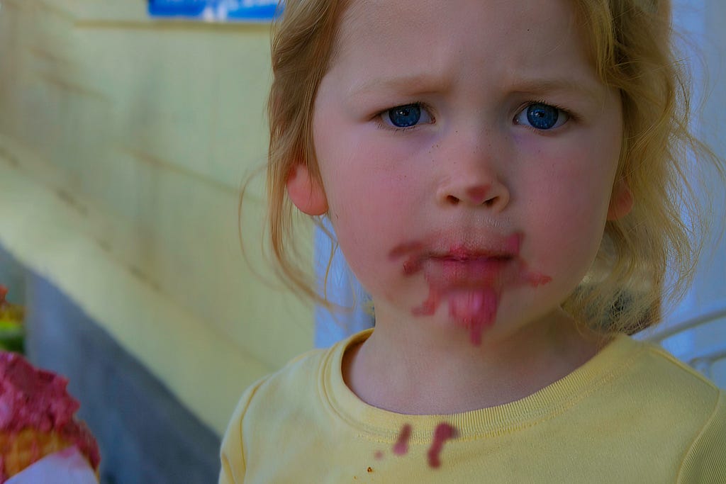 A child and ice cream on her face