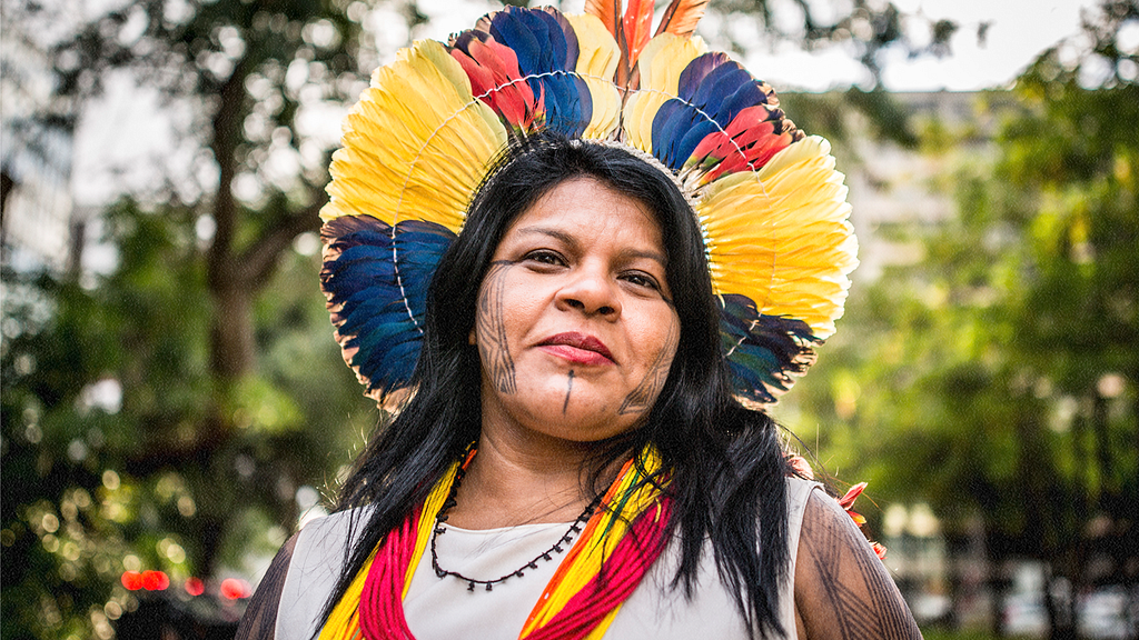 The activist Sonia Guajajara photographed in traditional headdress.