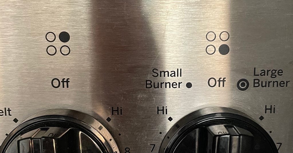 The knobs on a stove control panel.