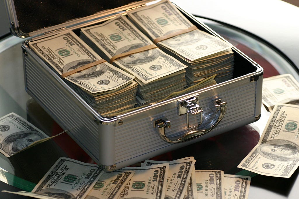 image of money in a case to represent money paid for a data breach settlement.
