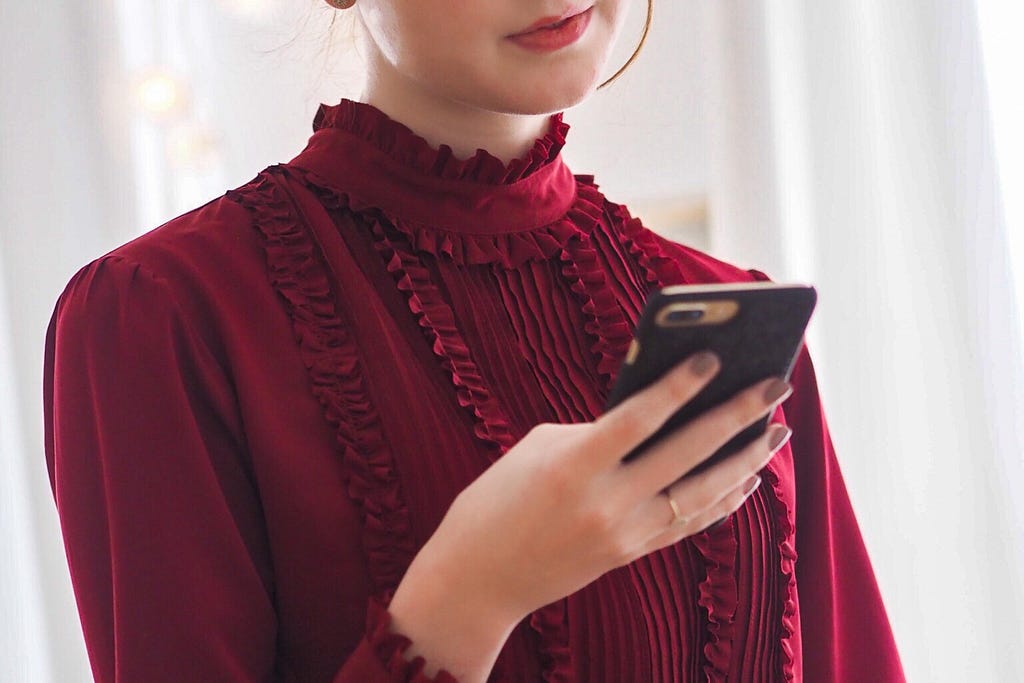 A woman looks at her mobile phone