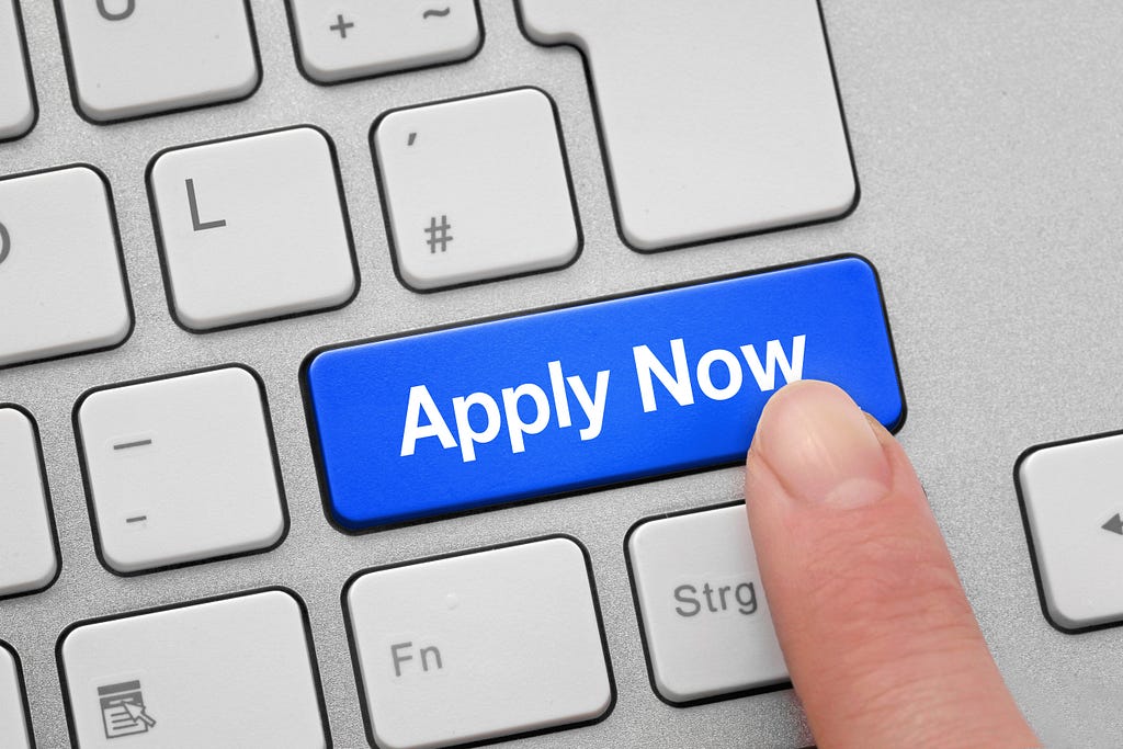 A computer keyboard featuring a clearly visible “Apply Now” button, emphasizing its importance.